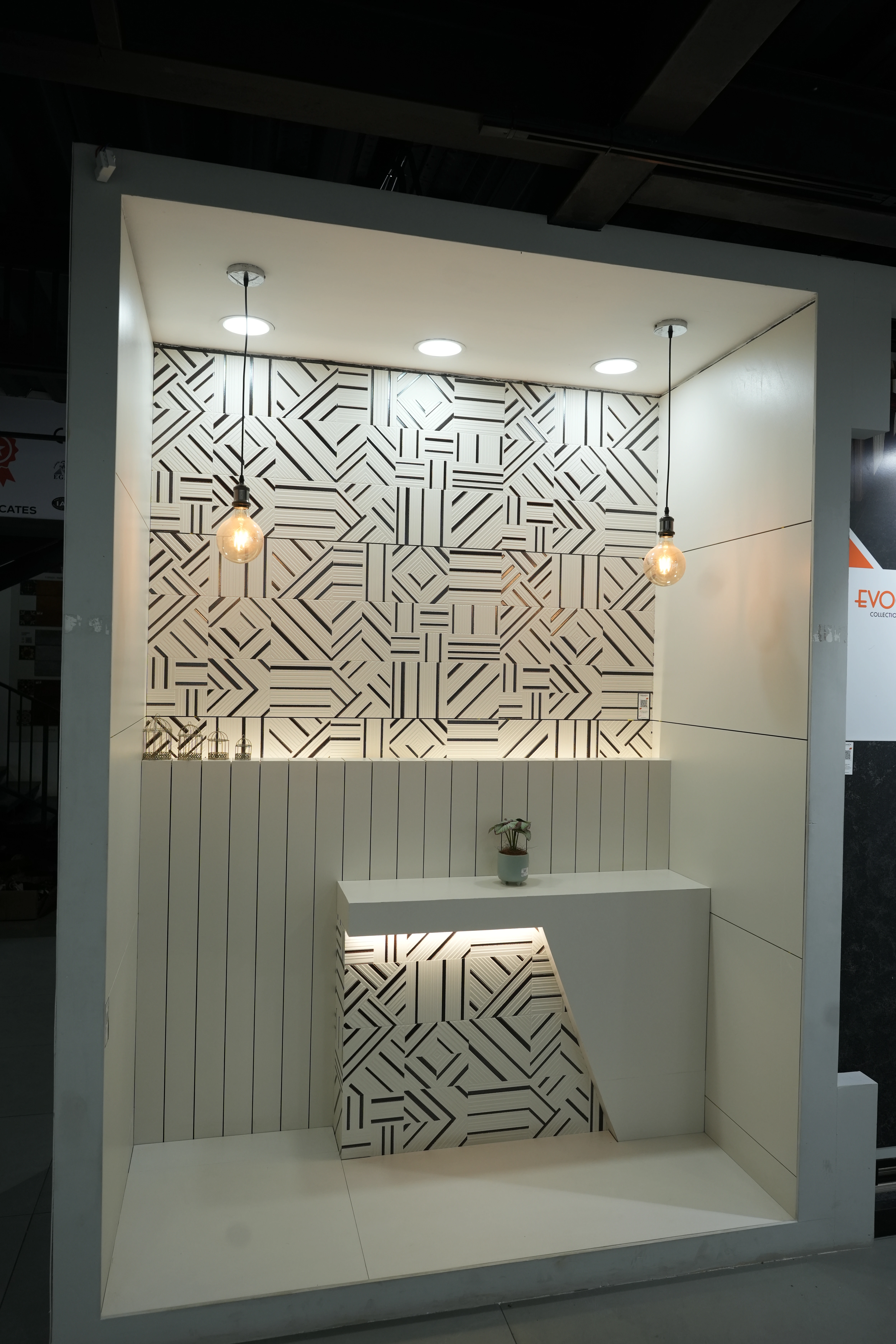 City Ceramics showroom featuring Creanza tiles with modern geometric patterns, illuminated by pendant lights, and minimalist countertop design