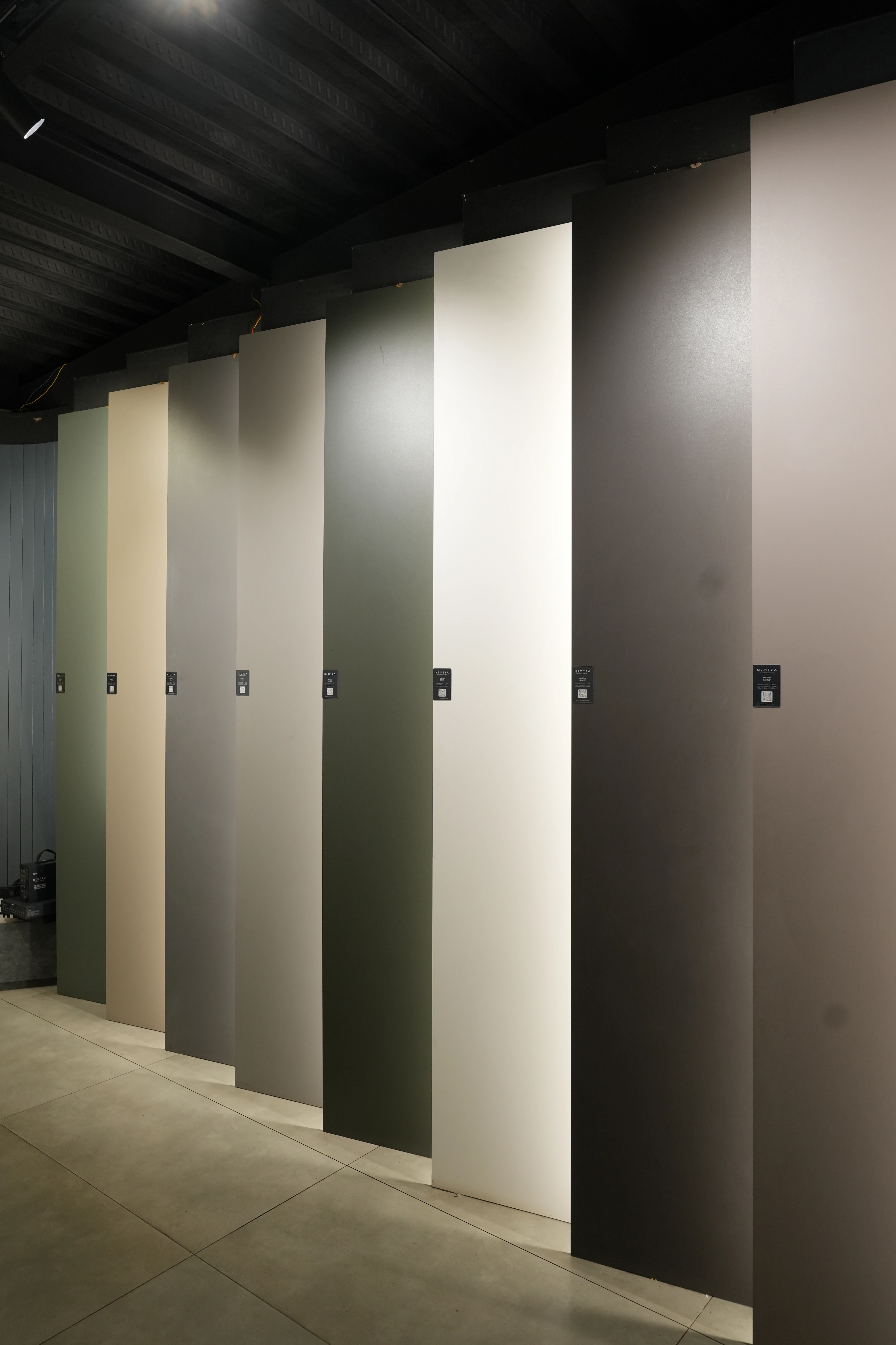 City Ceramics showroom displaying Neotra tiles in a variety of muted colors, showcasing sleek, modern wall panels.